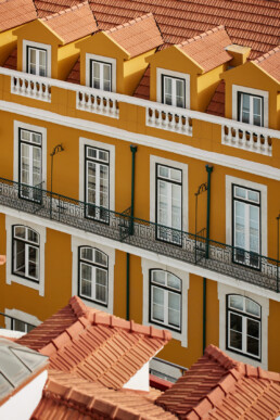typical yellow buildings with terracotta roof tiles in lisbon in portugal