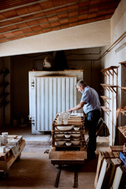 potter loading the kiln in an olaria in pottery village corval in portugal